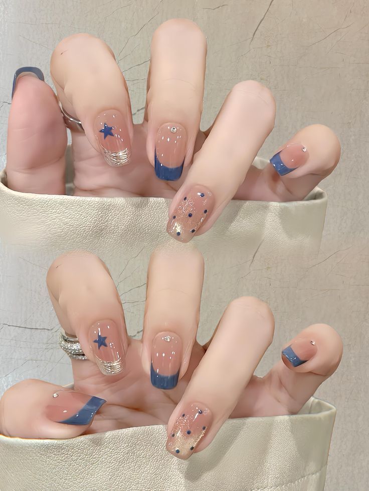 Những mẫu nail đẹp kiểu French tip xanh navy phối họa tiết ngôi sao và chấm bi ánh nhũ vàng, trẻ trung, năng động và cuốn hút.