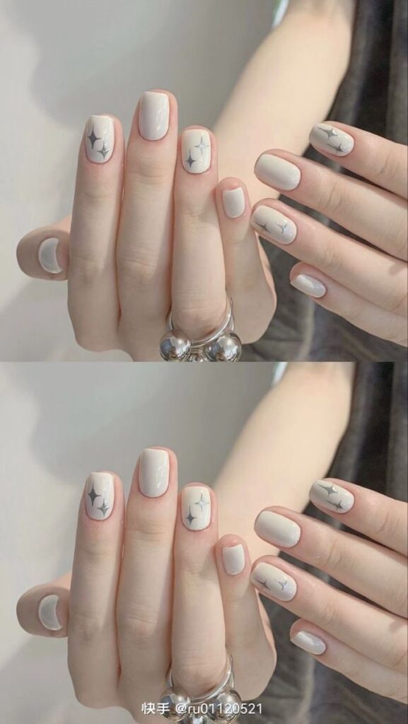 Nail màu trắng đơn giản dáng vuông ngắn nền trắng - xám ánh xà cừ, điểm họa tiết ngôi sao lấp lánh ánh bạc trẻ trung, cá tính.